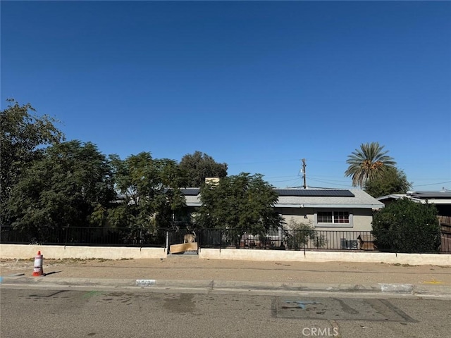 25626 Anderson Ave, Barstow, CA 92311 - obstructed view of property with a fenced front yard and roof mounted solar panels