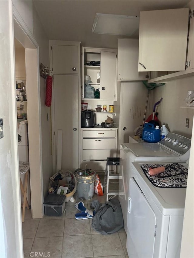 25626 Anderson Ave, Barstow, CA 92311 - kitchen with open shelves, light tile patterned floors, washing machine and dryer, and white cabinets