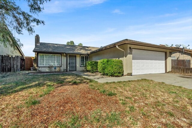 ranch-style house featuring a front lawn and a garage