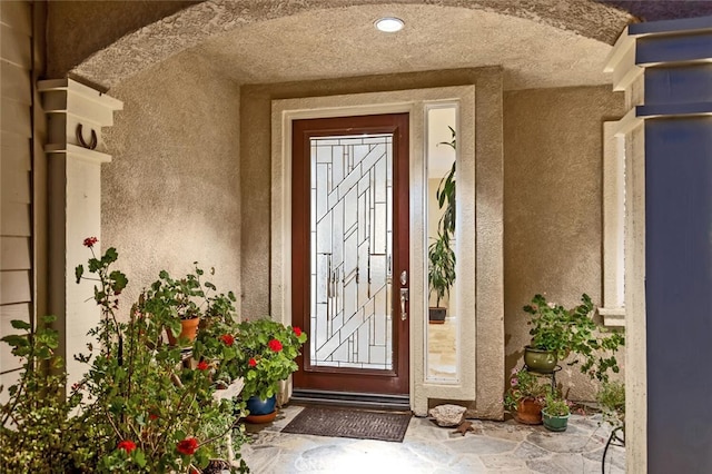 entrance to property with stucco siding