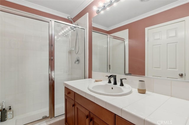 bathroom with vanity, a shower with door, and ornamental molding