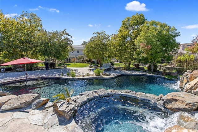 view of swimming pool featuring an in ground hot tub