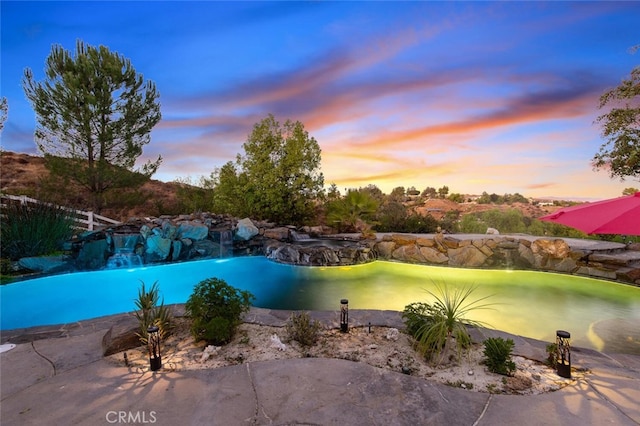 view of pool at dusk