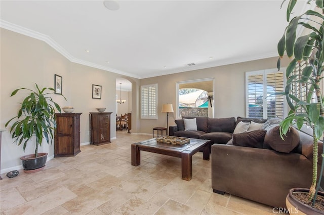 living area featuring baseboards, visible vents, arched walkways, and ornamental molding