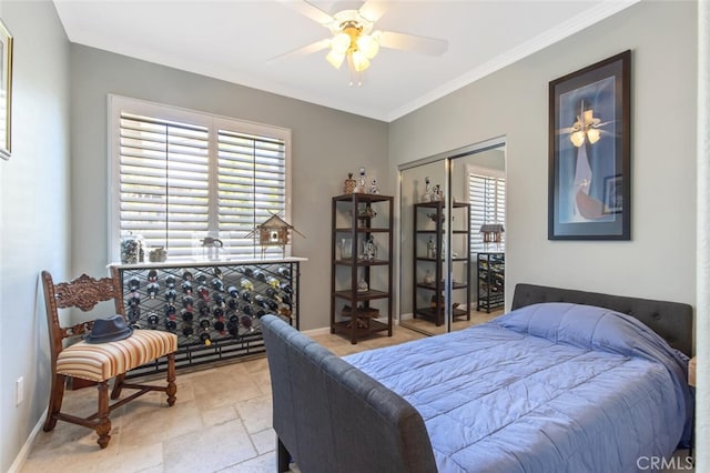 bedroom featuring a closet, ceiling fan, and ornamental molding