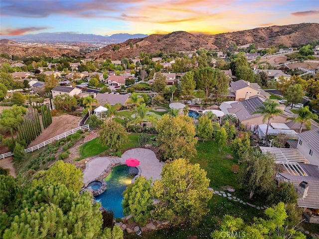 aerial view at dusk with a residential view and a mountain view