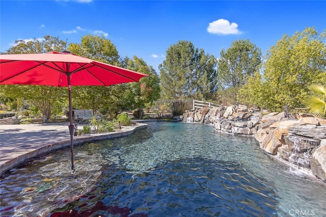 view of swimming pool featuring fence and a pool