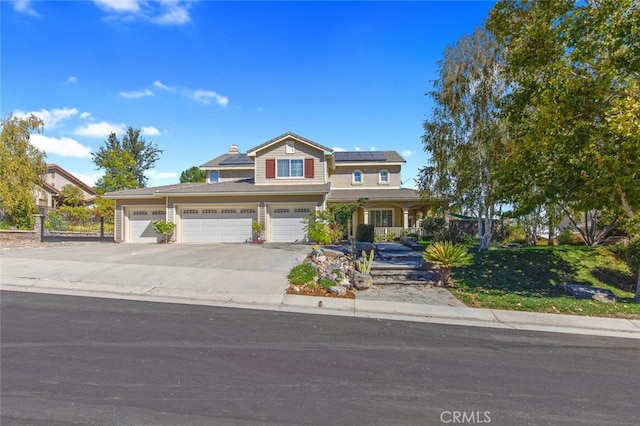 view of front of home with solar panels and a garage