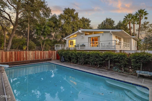 view of pool at dusk