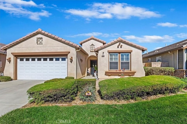 mediterranean / spanish-style house with a garage and a front yard