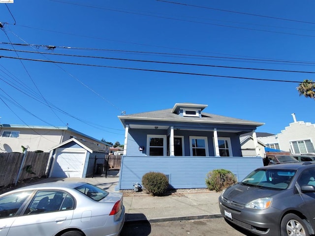 view of front of property featuring a garage and an outdoor structure