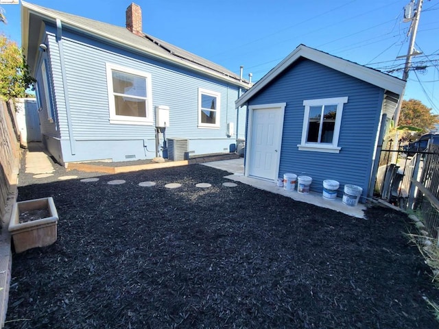 rear view of property with central AC unit