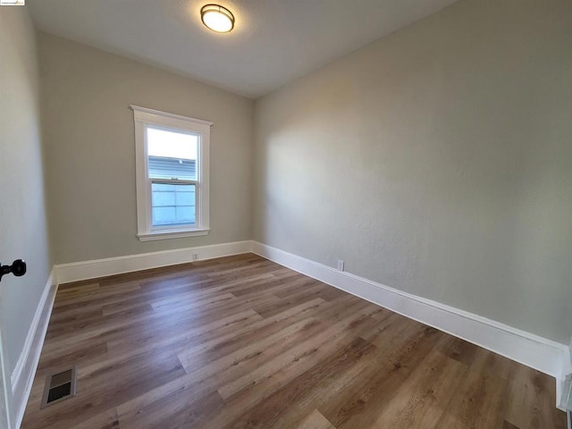 empty room featuring wood-type flooring