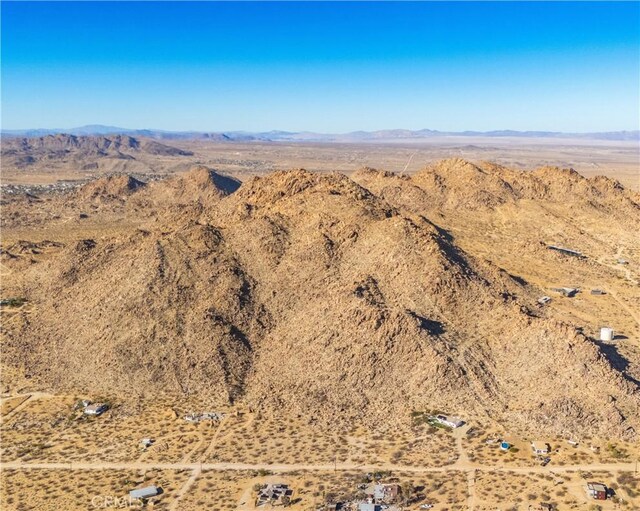 birds eye view of property featuring a rural view, a mountain view, and a desert view