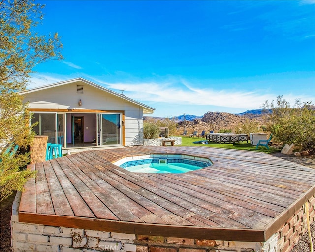 view of pool with a deck with mountain view