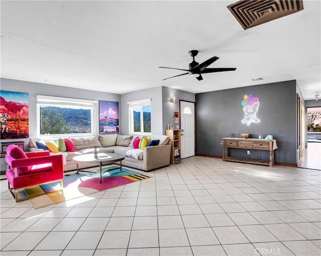 tiled living room with ceiling fan and a wealth of natural light