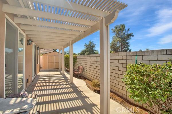 view of patio with a storage shed and a pergola