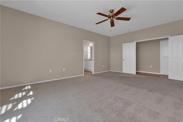 unfurnished bedroom featuring carpet flooring, ensuite bathroom, and ceiling fan