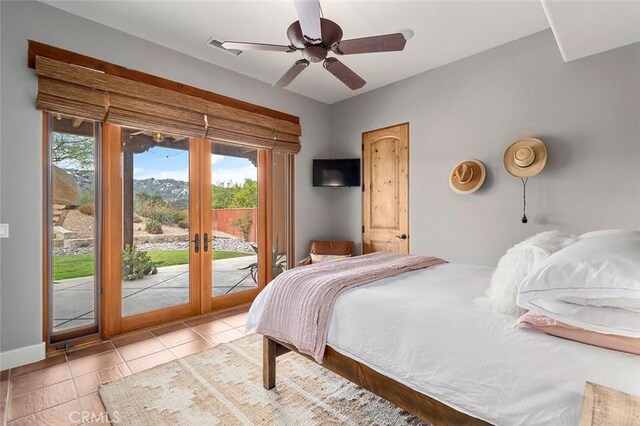 tiled bedroom featuring access to outside, french doors, and ceiling fan