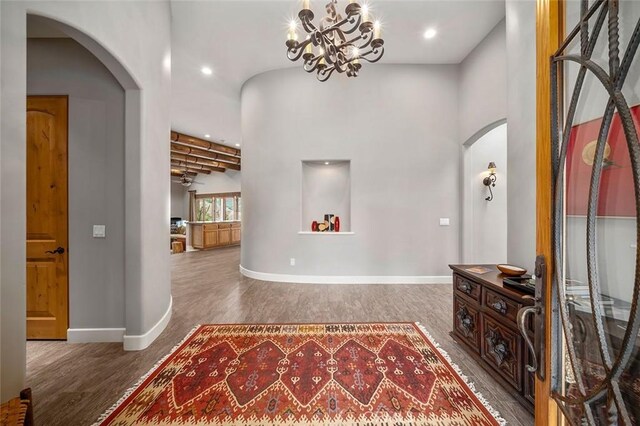 corridor featuring hardwood / wood-style flooring and a chandelier