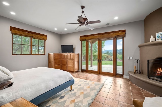 bedroom with multiple windows, access to exterior, light tile patterned floors, and ceiling fan