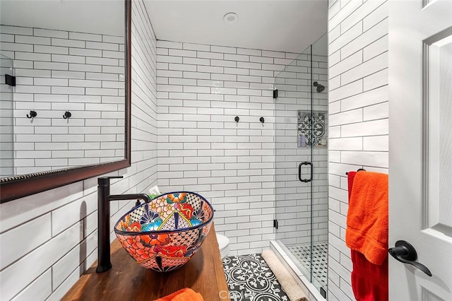 bathroom featuring toilet, an enclosed shower, hardwood / wood-style flooring, and tile walls