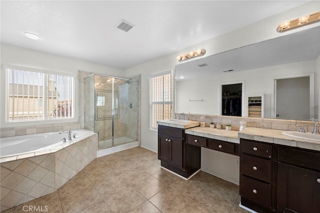 bathroom featuring a garden tub, vanity, visible vents, a shower stall, and tile patterned floors