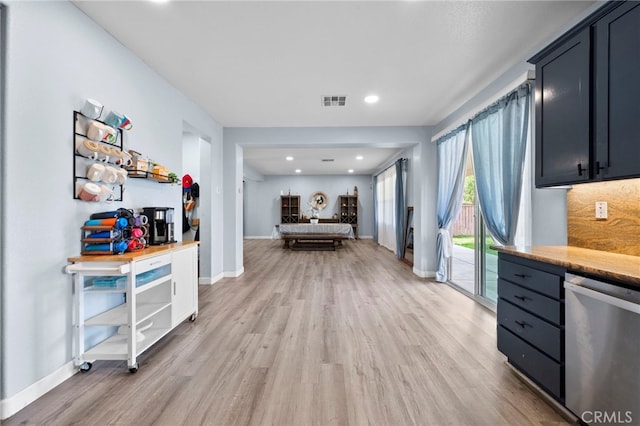 kitchen featuring visible vents, stainless steel dishwasher, open floor plan, light wood-type flooring, and baseboards