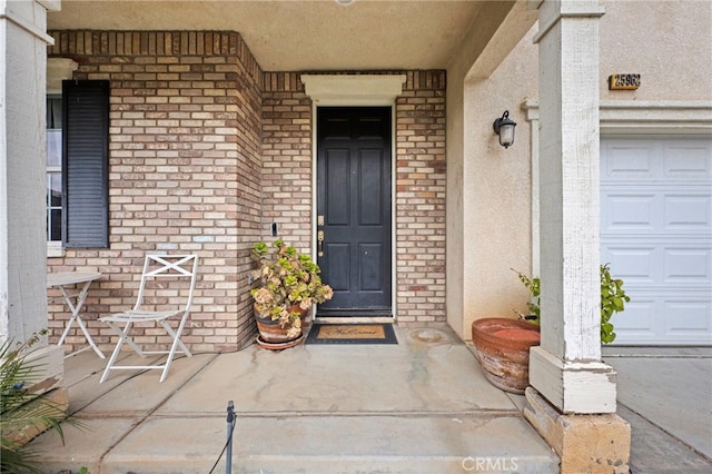 view of exterior entry with a garage