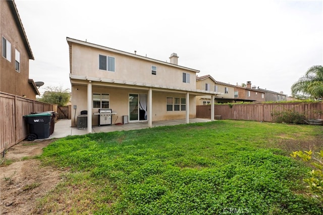 back of property featuring a patio area, a fenced backyard, stucco siding, and a yard