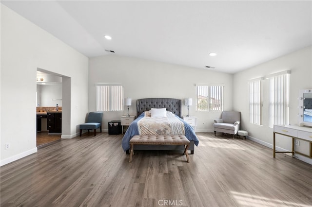 bedroom featuring baseboards, visible vents, wood finished floors, a sink, and recessed lighting