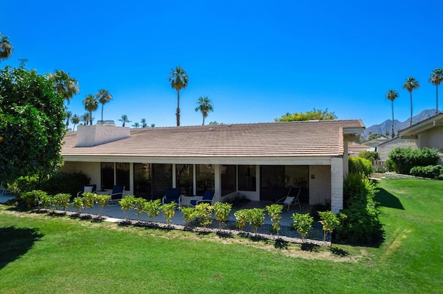 back of house with a yard and a patio area