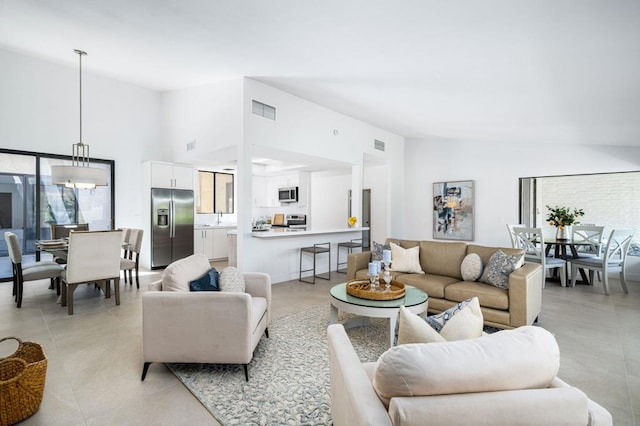 living room featuring a healthy amount of sunlight and high vaulted ceiling