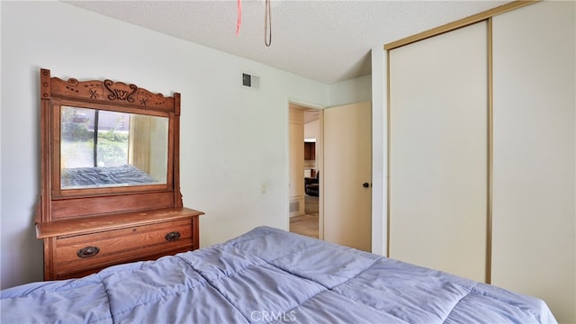 bedroom featuring a closet and a textured ceiling