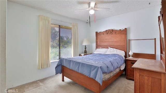 bedroom with light carpet, a textured ceiling, and ceiling fan