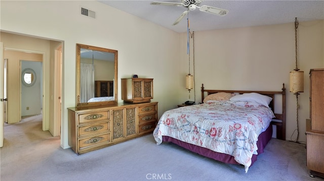 bedroom featuring a textured ceiling, carpet, and ceiling fan