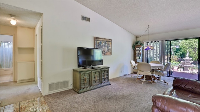 living room with a textured ceiling, high vaulted ceiling, and carpet flooring