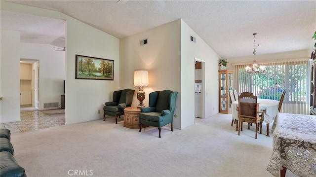 interior space featuring lofted ceiling, a textured ceiling, light colored carpet, and ceiling fan with notable chandelier