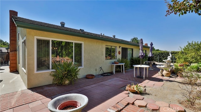 rear view of property featuring a patio area