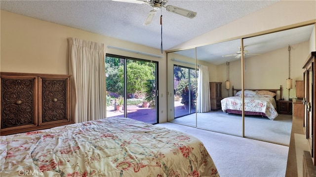 bedroom with ceiling fan, a textured ceiling, vaulted ceiling, a closet, and light colored carpet