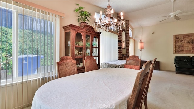 carpeted dining space with lofted ceiling and ceiling fan with notable chandelier