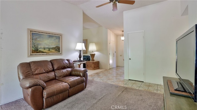 tiled living room with lofted ceiling and ceiling fan