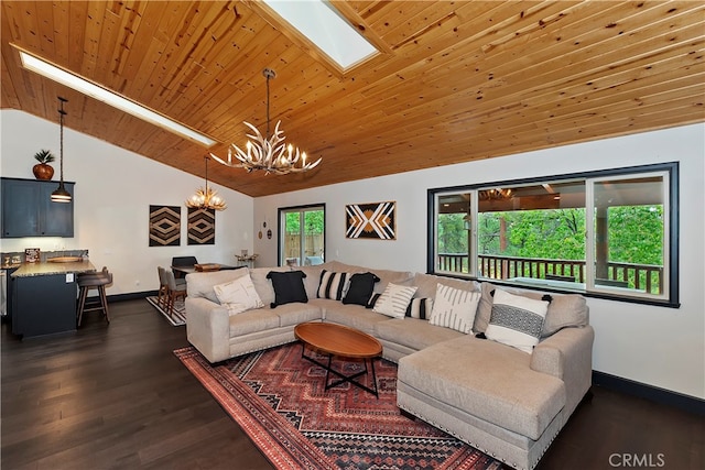 living room with lofted ceiling with skylight, a notable chandelier, a healthy amount of sunlight, and dark hardwood / wood-style flooring