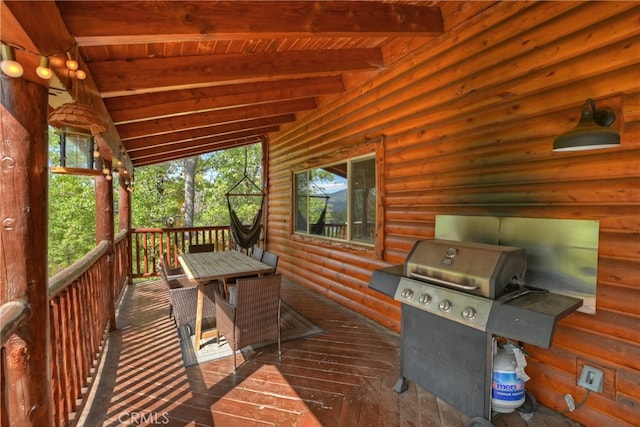 wooden deck featuring a grill