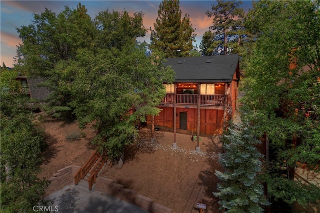 view of back house at dusk