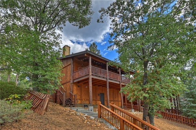 back of house with a wooden deck