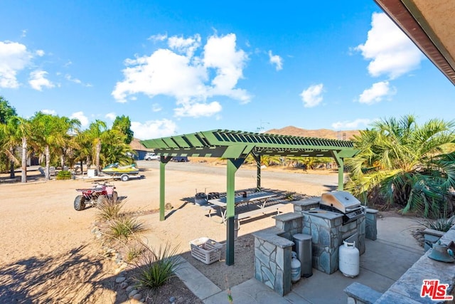 surrounding community with a pergola and a mountain view