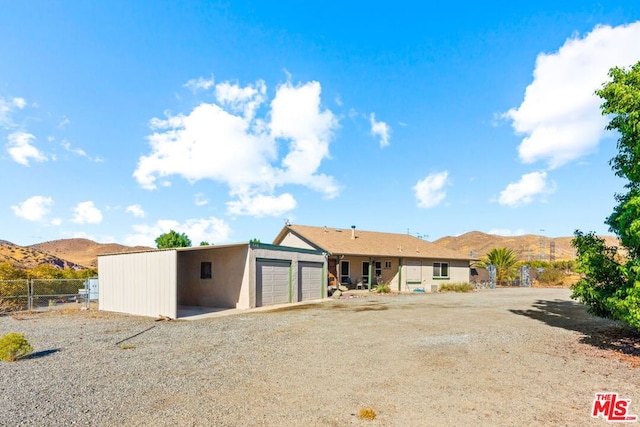 back of property with a mountain view