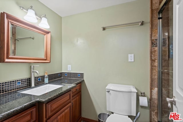 bathroom with toilet, vanity, and a shower