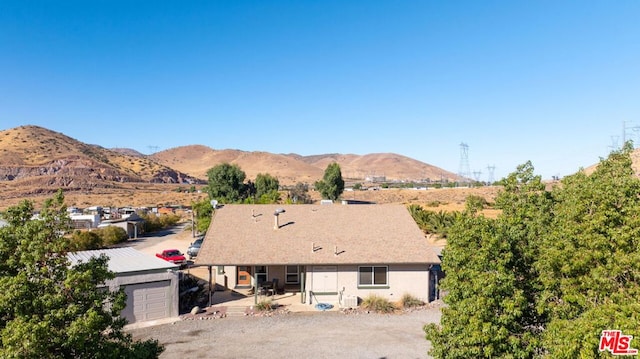 back of property featuring a patio and a mountain view